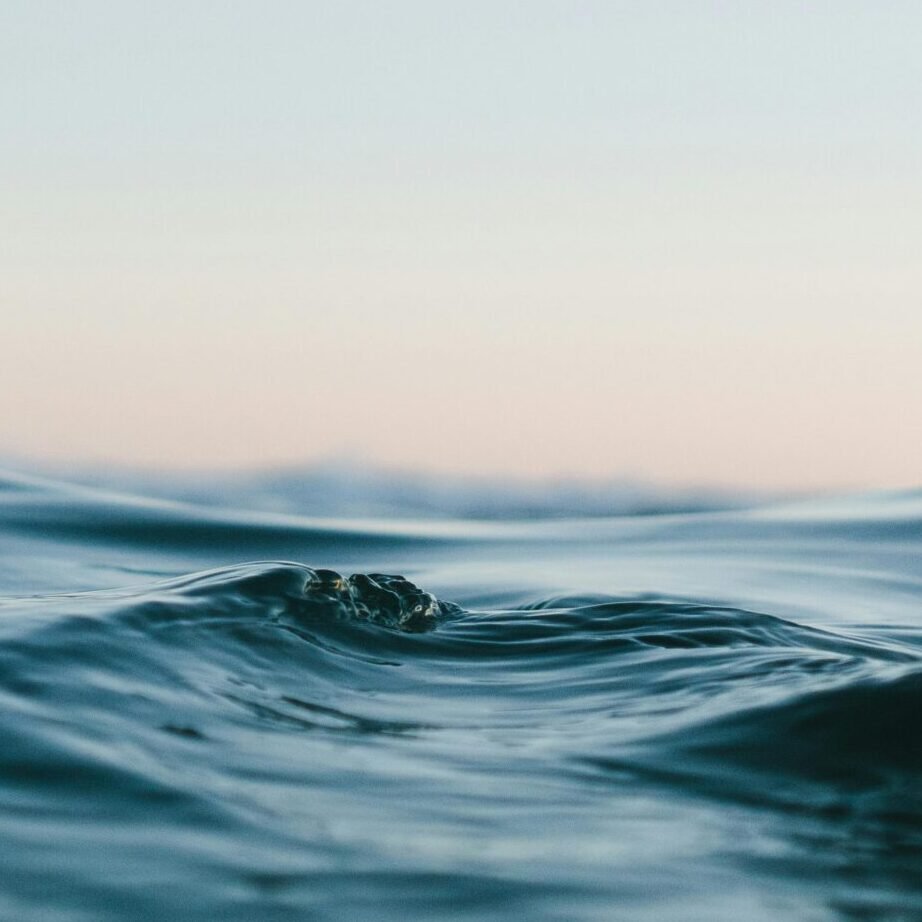 Tranquil ocean waves under a soft sunset sky, perfect for backgrounds.